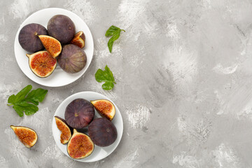 Fresh tasty fig fruits on concrete background, top view
