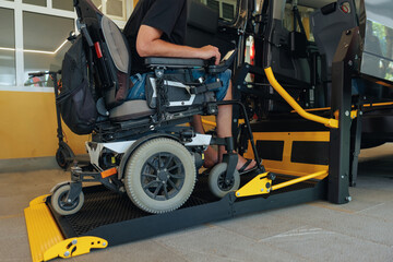 Person with disability in a wheelchair uses a ramp to enter a vehicle, demonstrating accessible transportation options in a modern setting.
