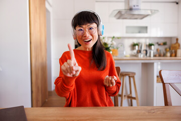 Woman having conference call while working remotely from home