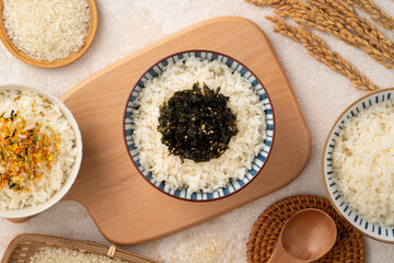 A bowl of white rice topped with rice seasonings.