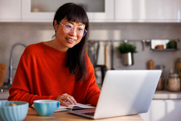 Woman working remotely from home having online meeting