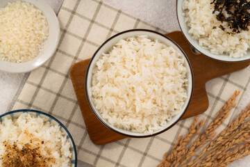 A bowl of white rice topped with rice seasonings.