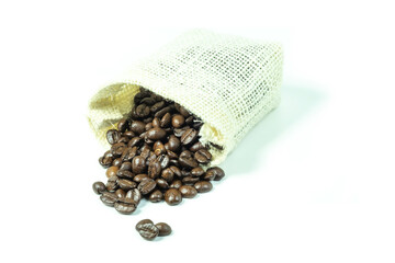 coffee beans in a sack, Group roasted coffee beans in whit sack bag and outside isolated on white background close up