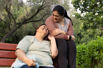 Indian old mature friends having fun, smiling together, comic bonding, comic face silly activity in park. Indian happy friends in nature park outdoors. Multi generational senior women fun at park