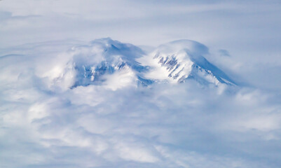 Aerial view of Mt McKinley rising above clouds