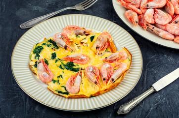 Appetizing omelette with seafood and greens.