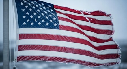 Fototapeta premium Tattered american flag waves in the Alaskan breeze on Patriot Day remembrance