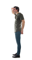Full length side view of casual young man looks attentive ahead as holds hand to forehead. Focused male searching with palm over eyes isolated on transparent background