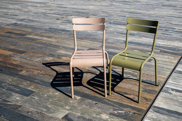 Two old empty chairs seem to be talking to each other.