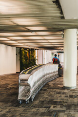 Airport staff pulling a ramp up with a vehicle baggage car.