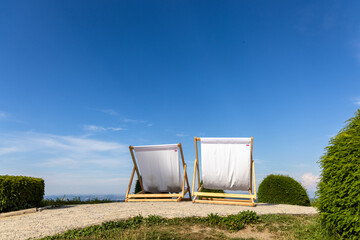 two large, inviting deckchairs with a view into the distance