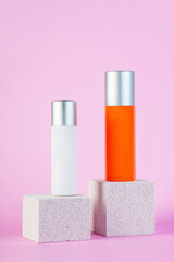 Skin care or sunscreen cosmetic with stylish props on pink background.