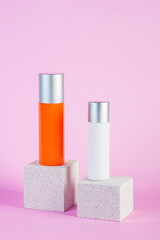 Skin care or sunscreen cosmetic with stylish props on pink background.