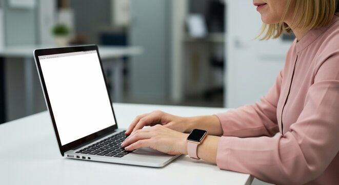 Woman working on laptop computer in office setting