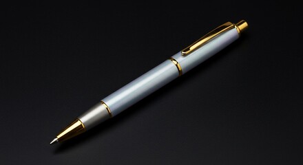 Elegant silver pen with gold accents on black background luxury writing instrument stock photo