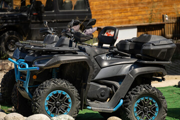 Two sleek, dark ATVs with bright blue accents. Ready for exhilarating outdoor recreation and...