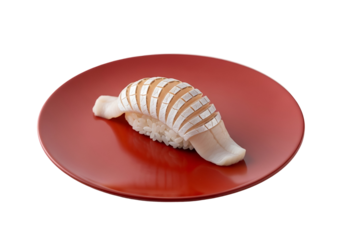 A visually striking squid sushi piece sits artfully on a polished red plate, showcasing intricate cuts and a delicate presentation.