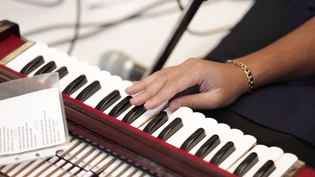 Close up of a hand playing indian classical music instrument harmonium