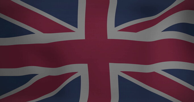 Fototapeta Displaying Union Jack flag filling frame on fabric backdrop, highlighting subtle texture and folds