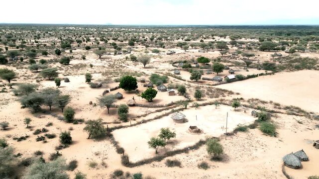 Aerial drone shot of a Northern Kenya village showing huts, landscape and home compounds