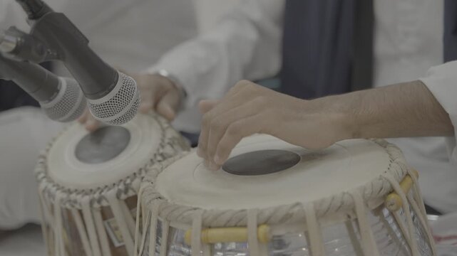 Close-up of hands of an indian man playing a paired tabla drum