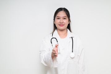 Fototapeta premium Portrait of Southeast Asian healthcare worker woman doctor in lab coat giving handshake
