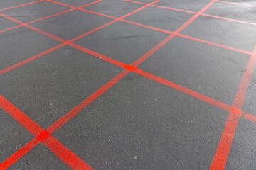 Fototapeta premium Red Squares Markings Lines Do Not Stop at Street Intersection Asphalt