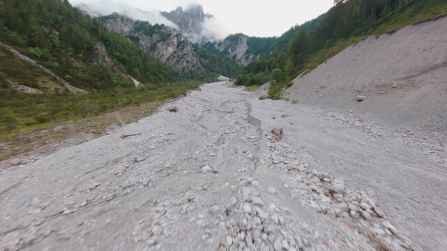 FPV drone shot of wilderness and dry river in Ges&auml;use National Park, Austria