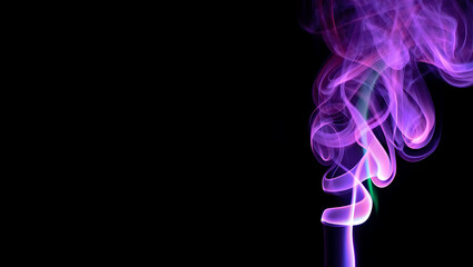 Neon smoke waves in purple, green, and pink colors glowing on black background. Futuristic light energy effect.