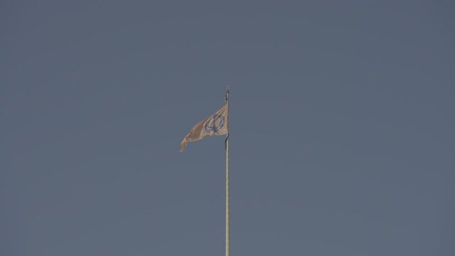 The Sikh Temple Flag Waves Proudly Against a clear blue sky