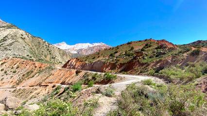 On the way to Iskanderkul mountain lake in Tajikistan, Asia. Amazing views of nature. A mountain range with a winding road