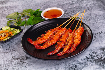 Grilled prawn skewer served sauce
