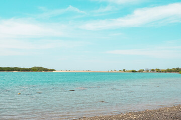 A beautiful landscape of the sea, beach, mangrove forest, and mountains in Baluran National Park. A view of the sea with a backdrop of mangrove forests and mountains in the summer. Baluran Sejile.