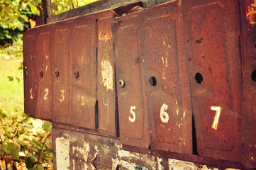 Opened old rusty metal mailboxes - shallow depth of field, vintage filter processing