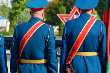A soldier in formal uniform stands in formation during a parade