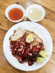 Savory char siu pork with rice and egg presented on a white plate for a culinary delight