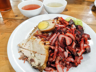 Aromatic display of asian cuisine featuring roast pork rice dish with flavorful additions