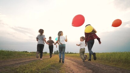 Child run with balloon across field, family and friend follow on grassy path, sibling and child hold colorful balloon while dog walks nearby under soft sunset sky, play and joy on open grass and path - Powered by Adobe