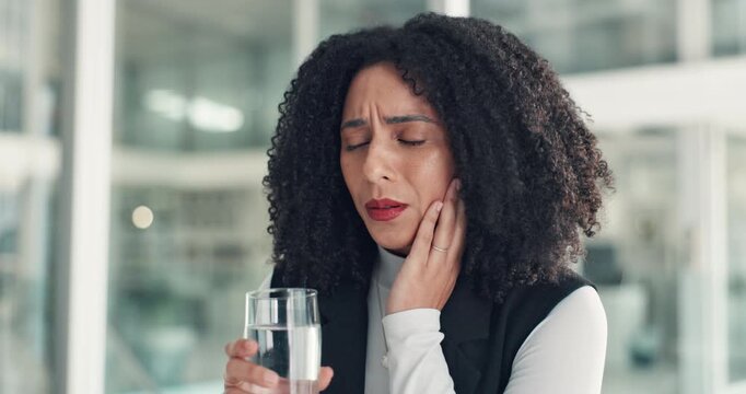 Woman, toothache and water at office with stress, fatigue or drink with oral hygiene at company. African person, glass and cavity with pain in mouth, dental care or gum disease at creative agency