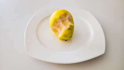 Bitten Pear on Plate White Background