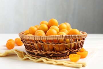 Ripe yellow cherry plums on white wooden table, closeup