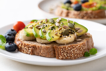 Avocado toast with banana, sunflower seed, pumpkin seed, sesame seed and blueberry, Healthy eating