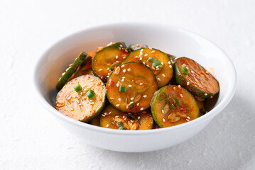 Korean cucumber salad (Oi muchim) in bowl on white background, Korean side dish