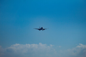 Passenger Airplane in Flight Against Blue Sky and Clouds Travel, Aviation, Freedom, and Transportation Concept