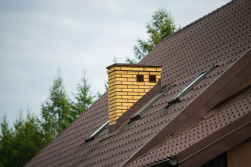 brick chimney on the roof of the house