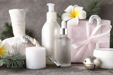 Beautiful spa composition with Christmas gift and fir branches on grunge background