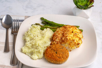  baked cod with crab cakes  and sauteed asparagus