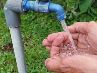 Washing Hands Under Outdoor Faucet: Promoting Hygiene, Health, and Freshness in a Natural Green Environment