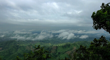 Misty clouds rolling over verdant green hills rolling hills