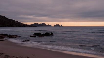 Cape Vilan Lighthouse and Reira beach in Camari&ntilde;as, Galicia, Spain. First electrical lighthouse in Spain. This lighthouse was the first electrical lighthouse in Spain.